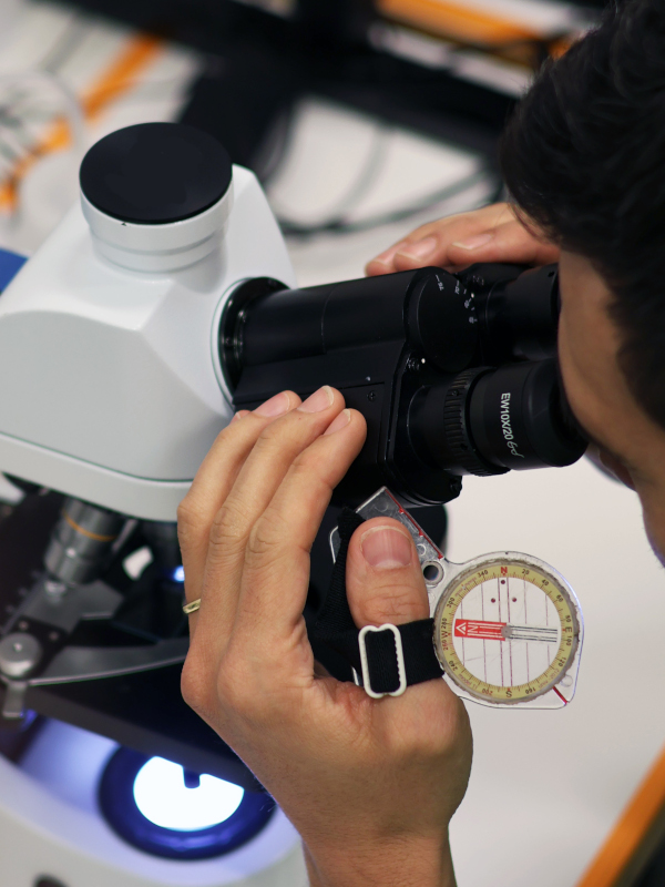 Microscope and compass representing research and orienteering