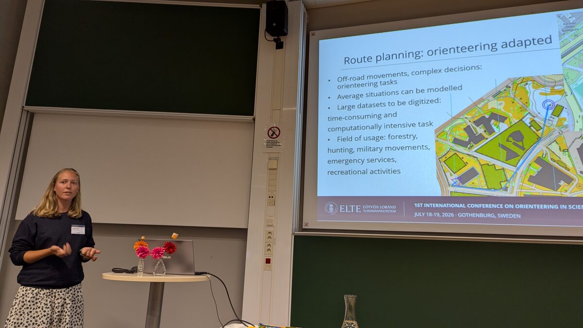 A speaker presenting research about route planning in orienteering